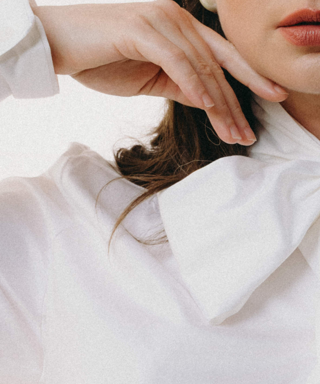 Close-up of a person wearing a white shirt with a high collar.