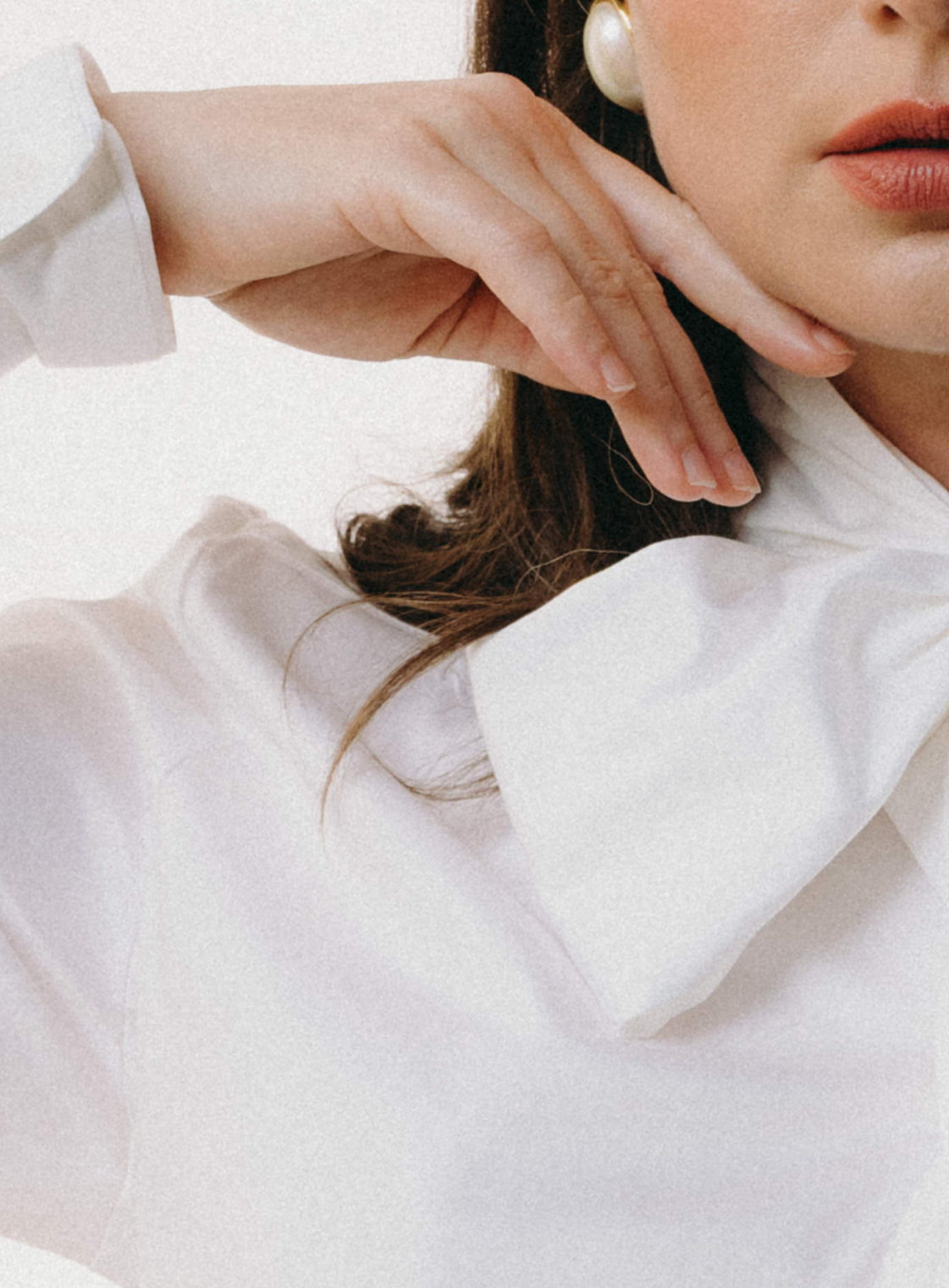 Close-up of a person wearing a white shirt with a high collar.