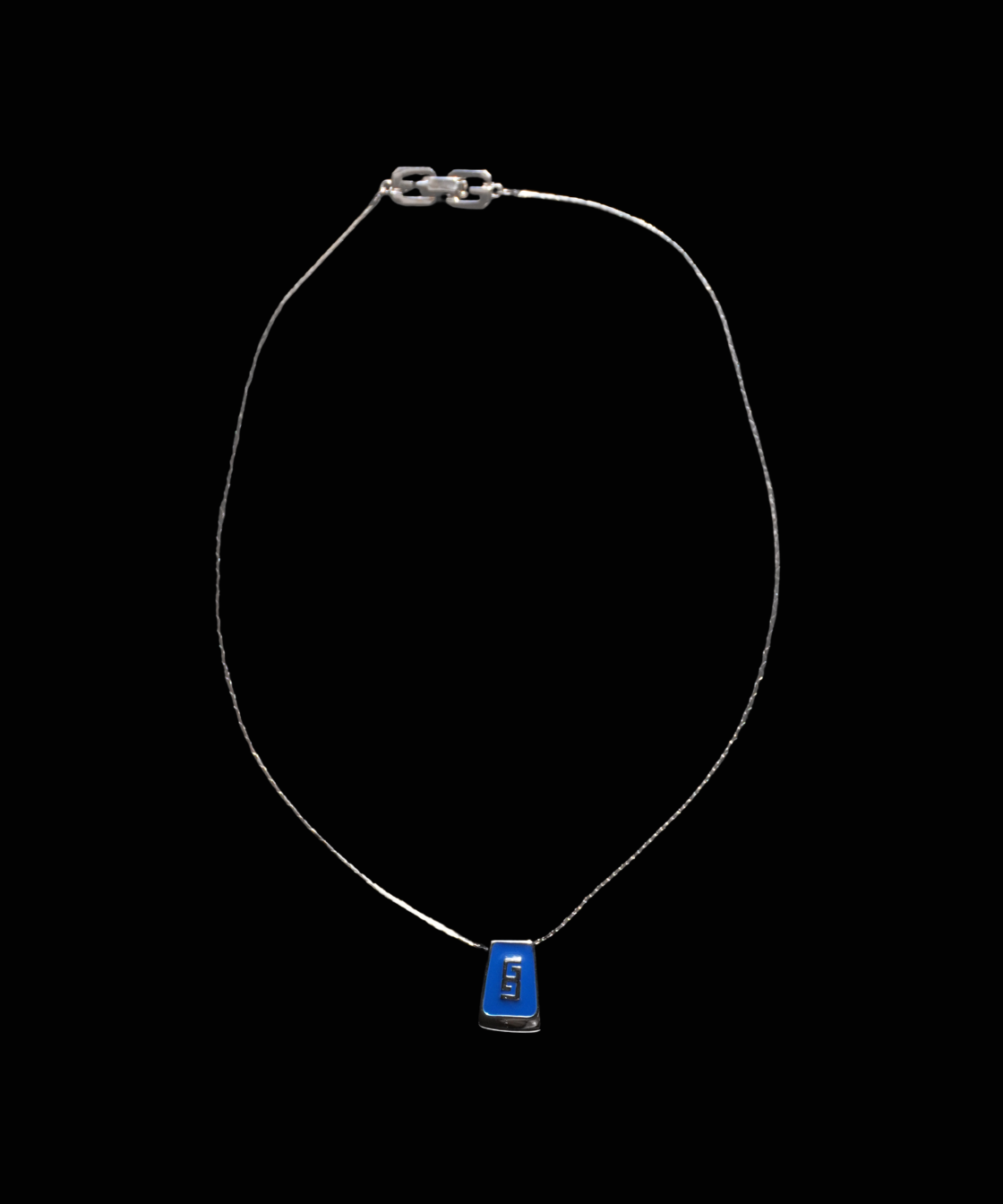 A silver Givenchy chain necklace featuring a small rectangular blue pendant with white text, displayed against a solid black background.